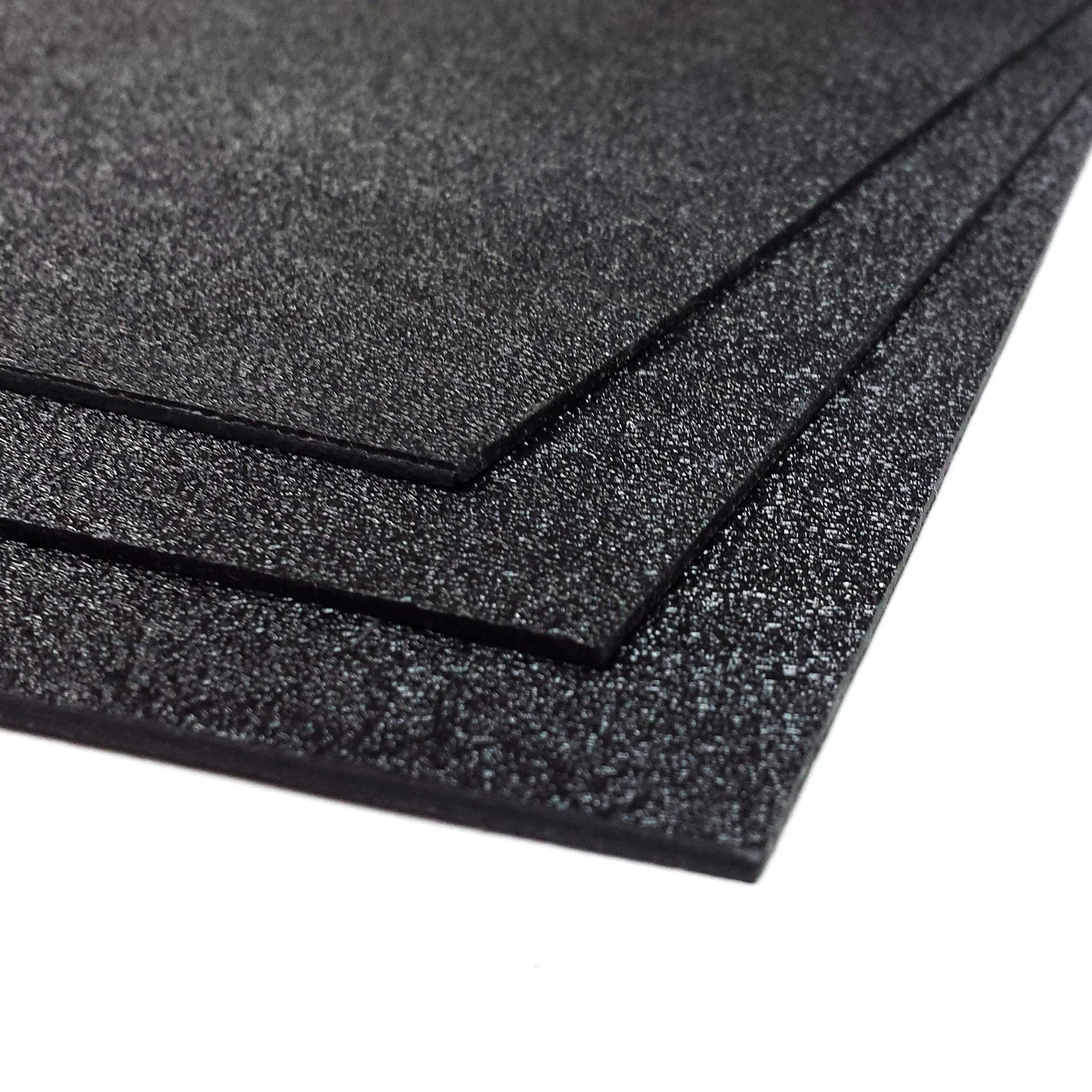 Textured black ABS plastic sheets stacked for advertising, construction, industrial use