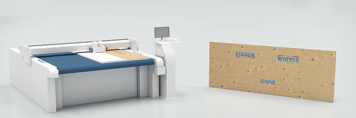 Large cutting machine next to Stadur wood panel for construction or advertising production