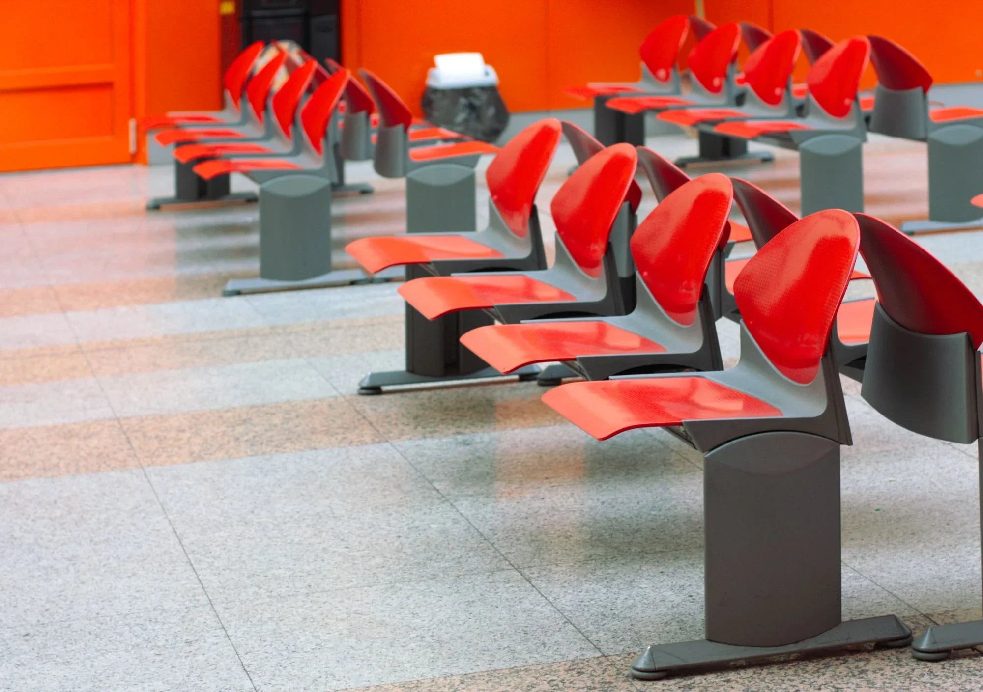 Red and gray ABS plastic waiting area chairs in a modern public building