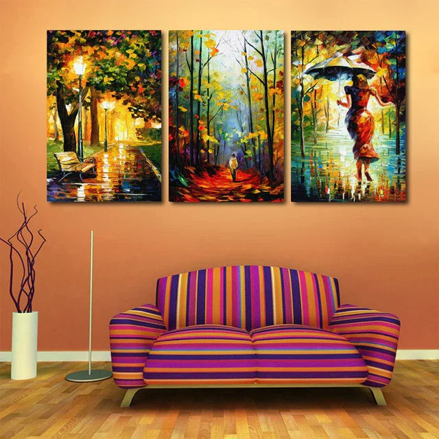Colorful abstract canvas wall art with autumn trees and figures, above striped sofa in modern living room