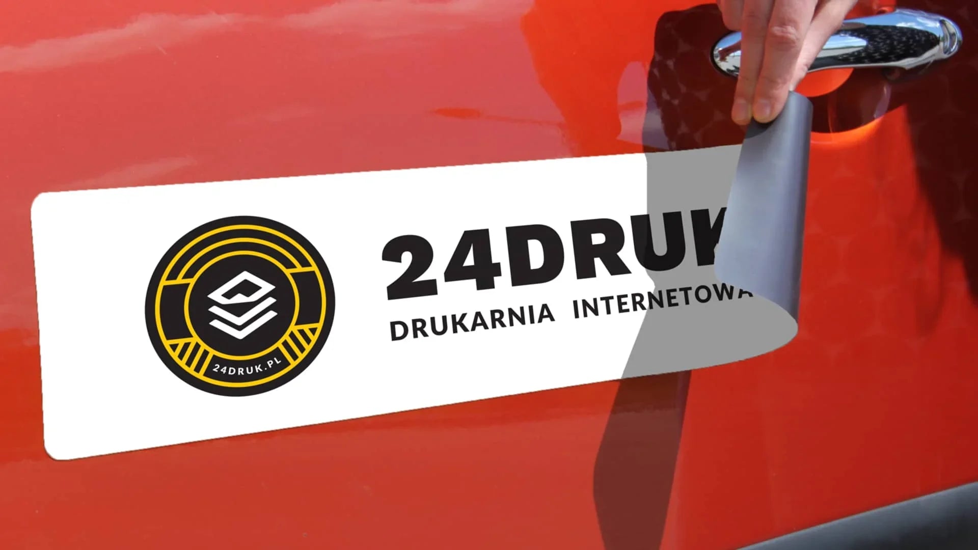 Magnetic car sign with black and yellow logo and text applied to red vehicle door