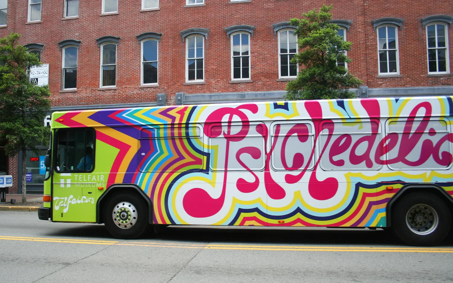 Colorful bus with psychedelic wrap advertising materials for advertising production