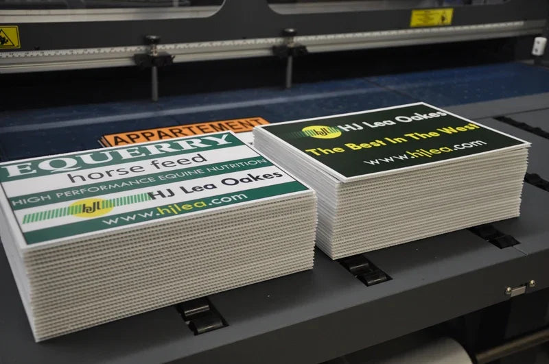 Stacks of printed advertising corrugated plastic signs for equine nutrition and feed