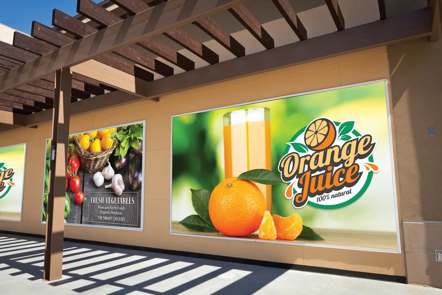 Outdoor advertising banners showing fresh vegetables and orange juice on a building wall