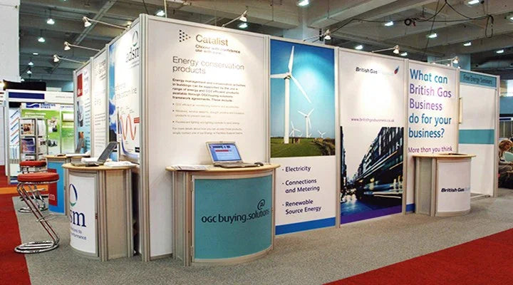 Trade show booth with product display counters, printed graphic panels, and company information.