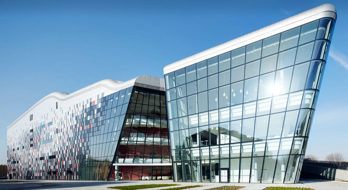 Modern commercial building with glass facade and geometric exterior, construction materials