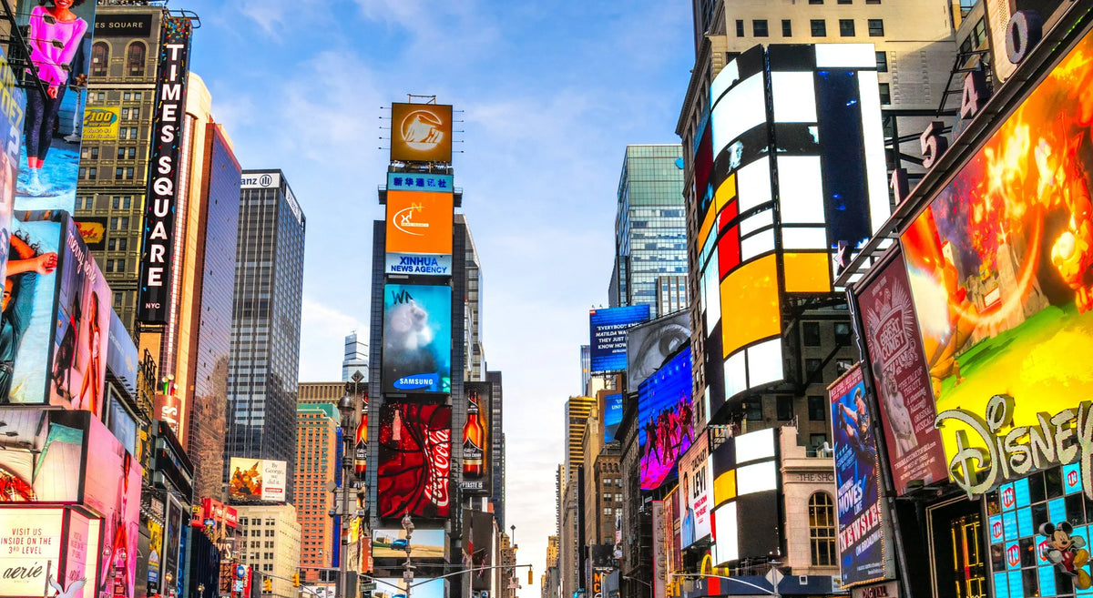 Colorful advertising billboards and digital signage on city buildings in an urban setting